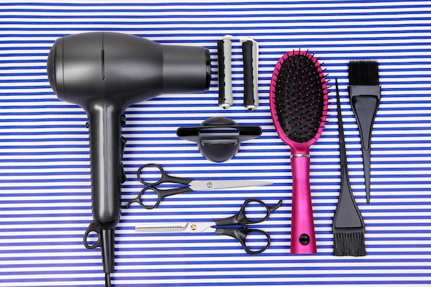 Photo hairdressing tools on striped blue background