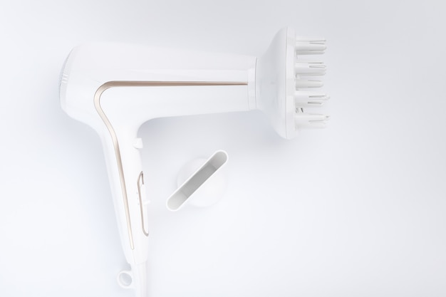 Photo hairdryer for drying hair with a diffuse and flat nozzle for styling on a white background