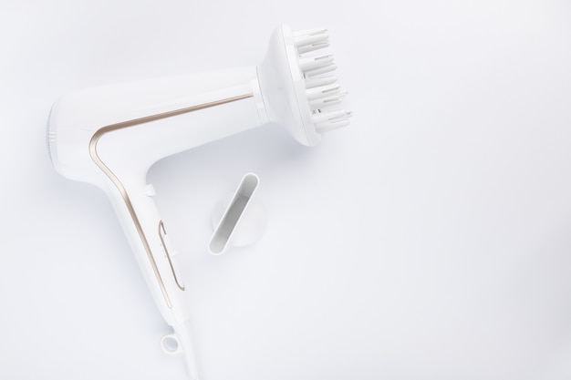 Hairdryer for drying hair with a diffuse and flat nozzle for styling on a white background