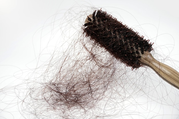 Hairs fall in comb hair fall everyday serious problemon white background