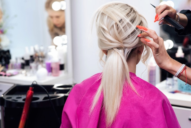 Hairstyle bun for a blonde girl with long hair