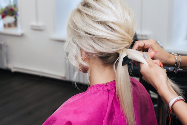Hairstyle bun for a blonde girl with long hair