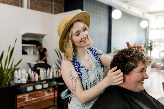 Hairstylist trimming hair of the customer in a beauty salon