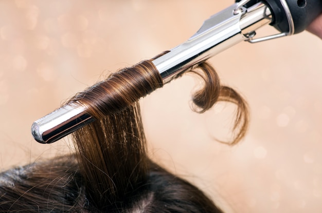 Hairstylist using a curling iron or tongs