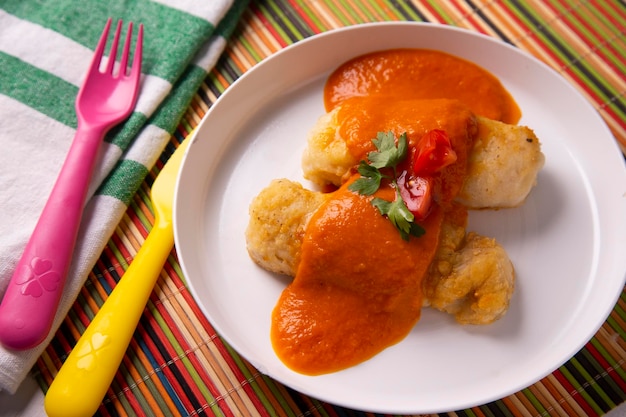 Photo hake battered with tomato sauce.