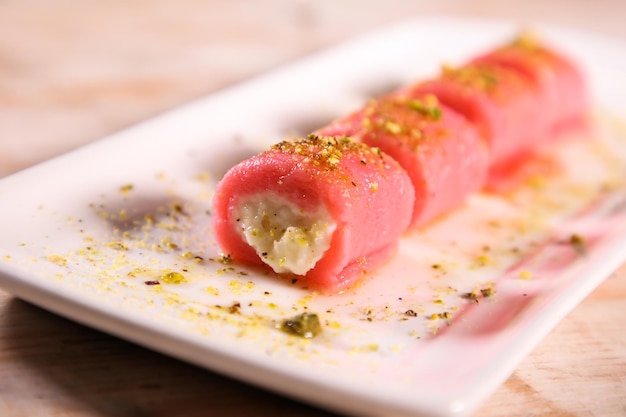 Halawat al jibin bil ward sweet served in dish isolated on table top view of arabic dessert