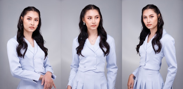 Half Body Portrait of 20s Asian beautiful tanned skin Woman black hair wear pastel blue formal dress. Office Female express feeling smile happy confident at work many poses over gray Background