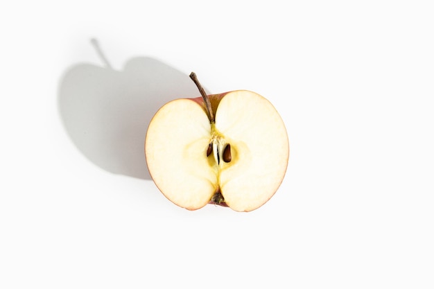 Half of a cut apple on a white background Top view flat lay