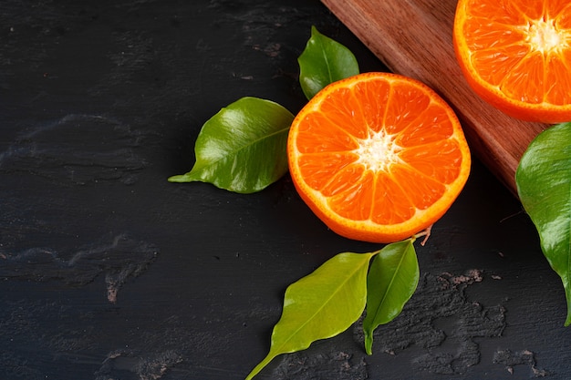 Half cut orange with green leaf on table