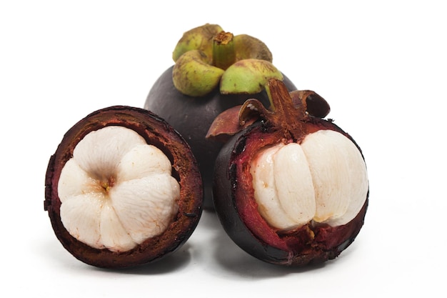 Half cut sliced and two whole fresh organic mangosteen delicious fruit isolated on white background