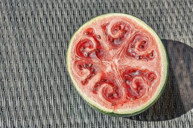 Half of delicious ripe watermelon with dry surface and seeds isolated on white background closeup