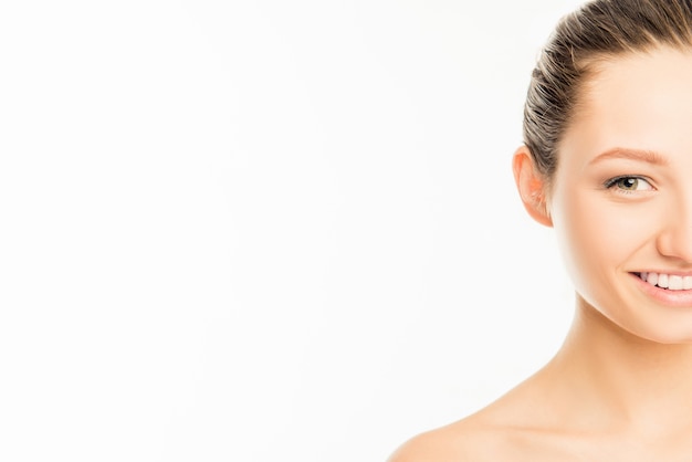 Half-face portrait of cute smiling woman on white background