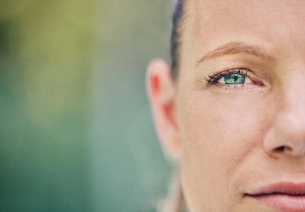 Half face and portrait of a woman at tennis with vision motivation and serious about a game Mockup focus and sports player looking serious while playing sport on a court and bokeh background