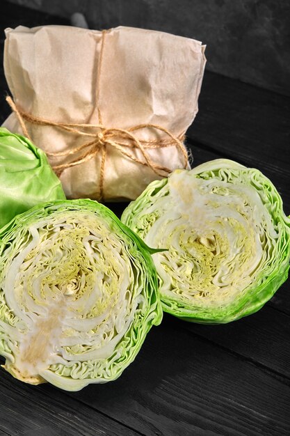 Photo half of fresh cabbage on dark background