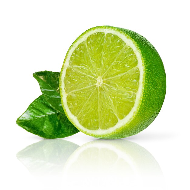 Half of fresh green lime with leaves isolated on white surface. Citrus fruits.