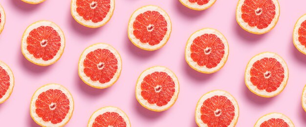 Half grapefruit on a pink background.