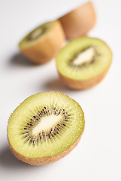 Half kiwi fruits on white background