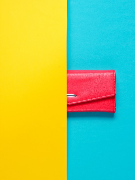 Half leather wallet on yellow-blue table. Top view