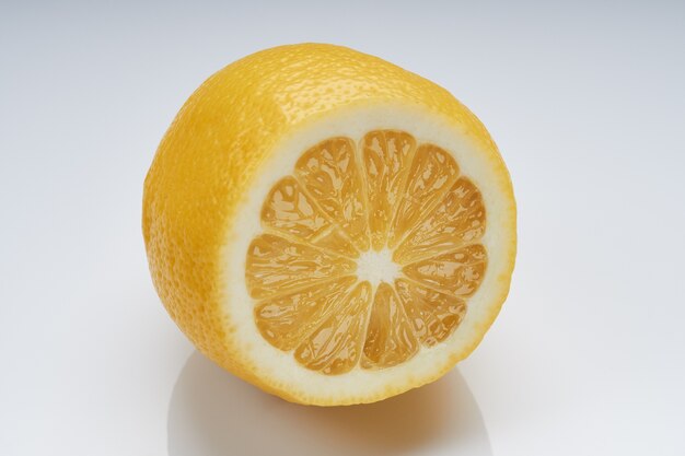 Half a lemon on a bright glossy surface