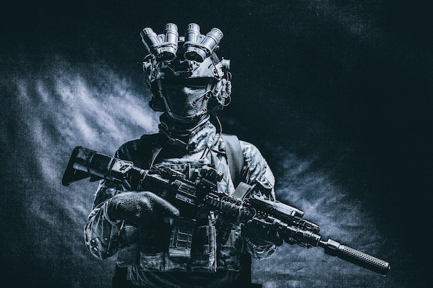 Half length, low key studio shoot of army soldier, marine\
infantryman in mask, camo uniform, equipped modern ammunition,\
armed service rifle standing in darkness with night vision device\
on helmet