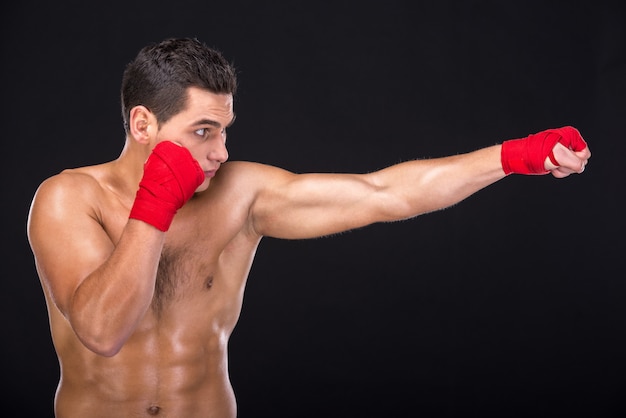 Half-length portrait of young nude boxer.