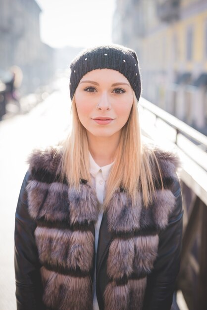 Half length of a young beautiful blonde straight hair woman in the city