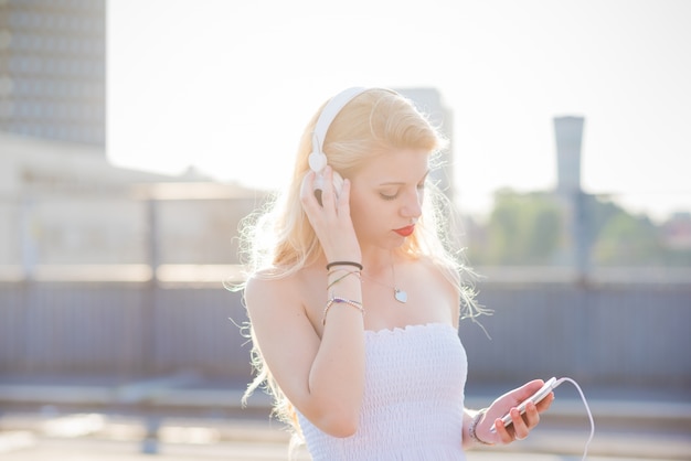 Photo half length of young handsome caucasian long blonde straight hair woman listening to music