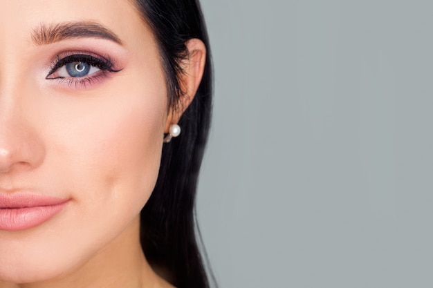 Photo half of the model's face to the left of the text space, close-up eye makeup. a concept photo for advertising cosmetics or makeup artist services.