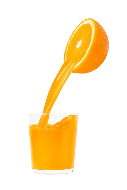 Half an orange in the air Juice pours out of it into a glass Isolated on white background