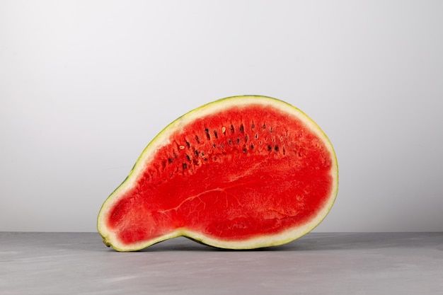 Half of pearshaped watermelon Deformed ugly watermelon Red pulp and seeds Eating imperfect foods