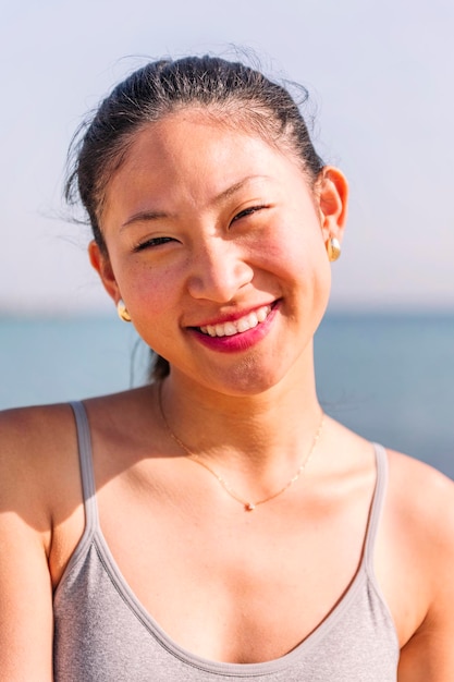 Half portrait of a young asian woman smiling happy