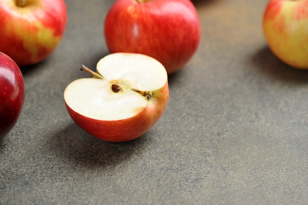 Half of a red Apple. Apples on a gray