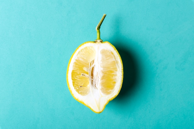 Half of ripe lemon on blue