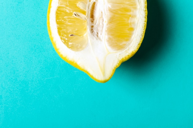 Half of ripe lemon on blue