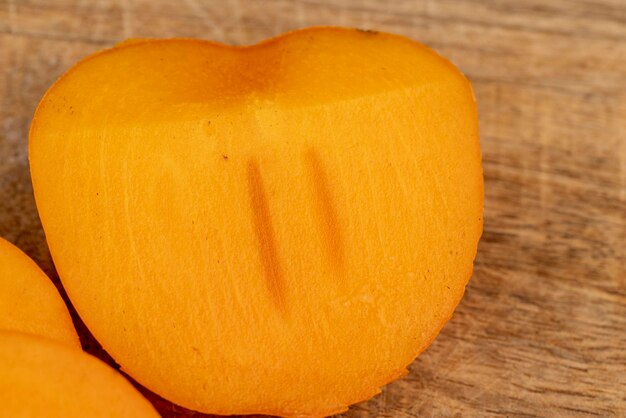 Half-ripe orange persimmon, close up