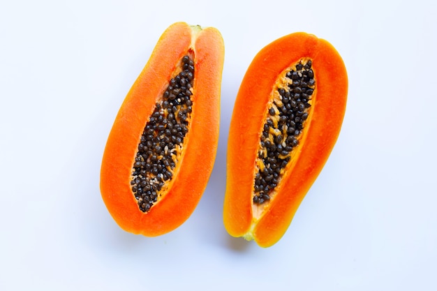 Half of ripe papaya fruit with seeds isolated on white background