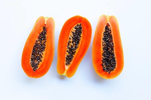 Half of ripe papaya fruit with seeds isolated on white background