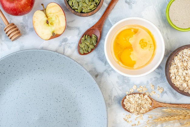 Half shot of empty gray plate and ingredients for the healthy food set on ice background