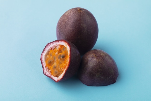 Half sliced passion fruit on blue background