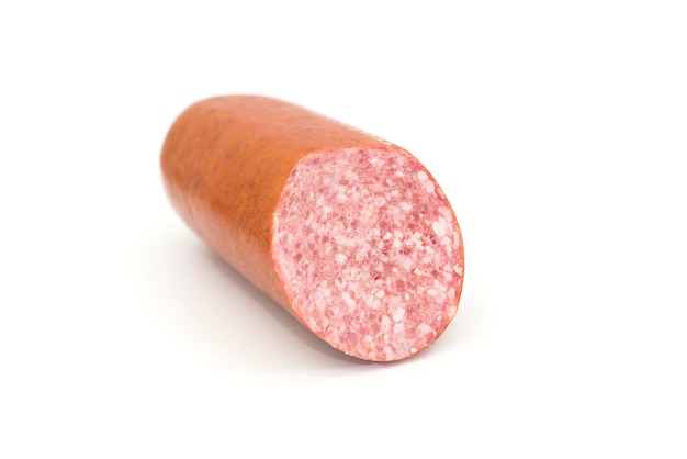 Half stick of sausage on a white plate. Cervelat on white