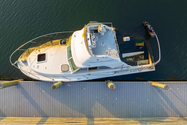 Half sunken sailing yacht capsized on shallow bay waters after hurricane Ian in Manasota Florida