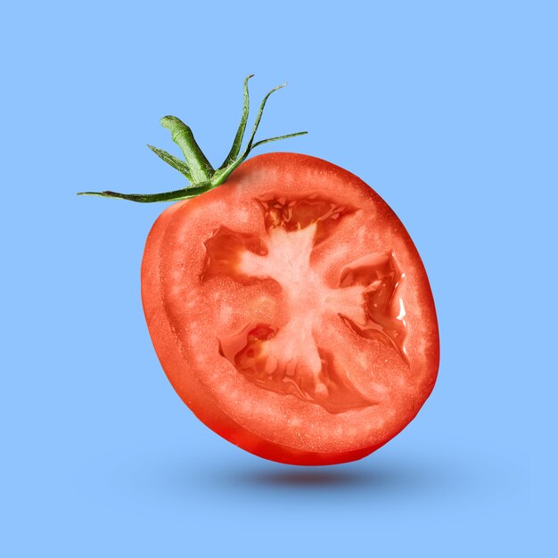 half tomato over a blue wall