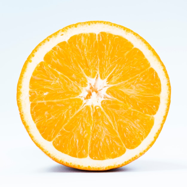 Photo half of tropical orange on white background