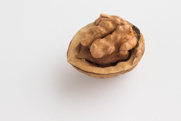 Half a walnut on a white background