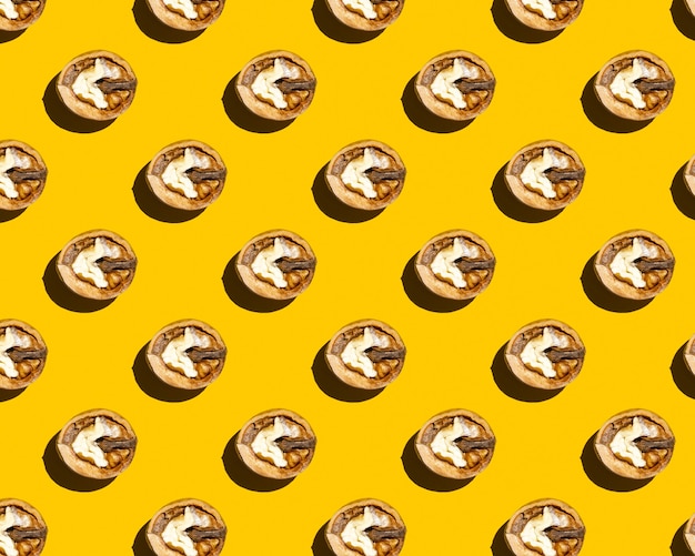 Half walnut on yellow background pattern