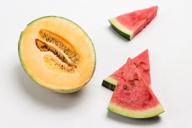 Half a yellow melon. Pieces of chopped watermelon.