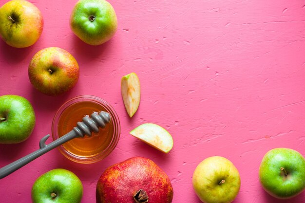 Halfframe of apples pomegranate and honey for the Jewish New Year horizontal