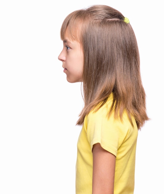 Halflength emotional portrait of caucasian girl wearing yellow tshirt Profile of funny cute child isolated on white background