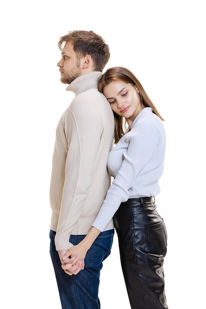 Halflength portrait of young loving couple posing hugging isolated over white studio background