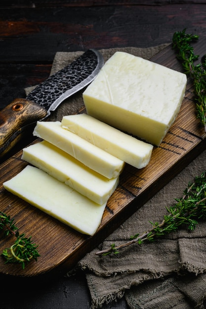 Halloumi Cheese fresh cut set on old dark wooden table background